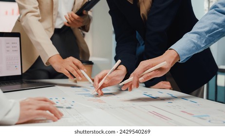 Closeup happy young Asia businesspeople meeting brainstorming some new ideas about project to his partner working together planning success strategy enjoy teamwork in small modern home office. - Powered by Shutterstock