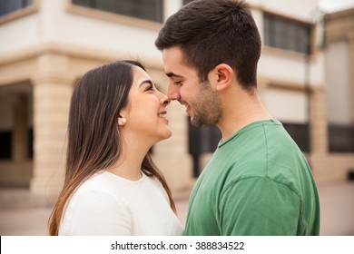 Closeup Of A Happy Young Couple Standing Very Close To Each Other And About To Kiss