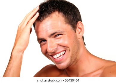 Closeup Of A Happy Young Man Looking At Camera And Touching His Hair