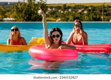 Closeup happy young women floating with air lilobal at pool party - Having fun on summer vacation - Travel, friendship, youth and tropical concep - Powered by Shutterstock