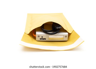 Closeup Of A Hard Disk Drive Inside A Padded Bubble Envelope Isolated On White. The Concept Of Careful Handling Of Shock Sensitive Equipment.