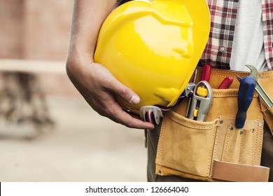 Close-up Of Hard Hat Holding By Construction Worker