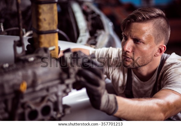 Close-up of hard\
working sweaty dirty\
mechanic