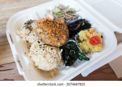 Closeup Of Hawaiian Style Takeout Plate Lunch, With Rice, Meat, And Vegetables In A Paper Takeout Container.