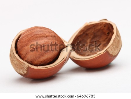 Closeup of hazelnut in cracked nutshell