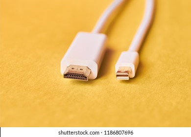 Closeup Of HDMI And Mini Display Port Cables On Yellow Background