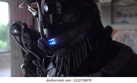 Closeup of head with hat of android with face. Footage. Android with glowing mouth and detailed male face on background of gray walls - Powered by Shutterstock - Get 15% off with code: PIKWIZARD15