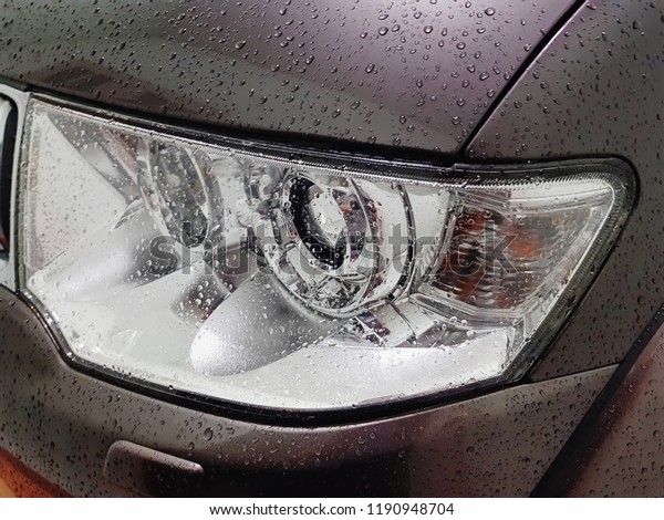 Close-up Head\
Lamp of SUV Car with Water\
Droplets