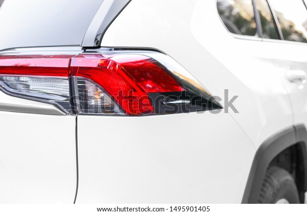 close-up of\
headlight of a white car. Premium\
car