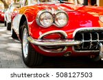 Close-up of headlights of red vintage car. Exhibition