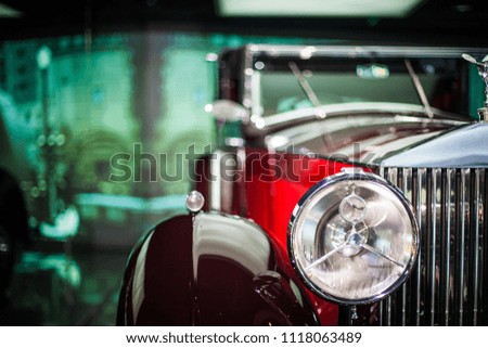 Close-up of headlights of red vintage car. Exhibition.