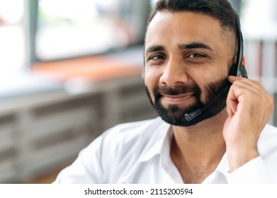 Close-up Headshot Of Attractive, Smart, Successful Indian Man, Consultant Or Top Manager, Successful Real Estate Agent, Wearing Headphones, Formal Wear, Looking At Camera, Smiling Pleasant