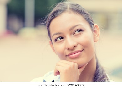 Closeup headshot portrait charming smiling joyful happy business woman looking upwards daydreaming nice future thinking isolated outside background. Positive emotion facial expression feelings 