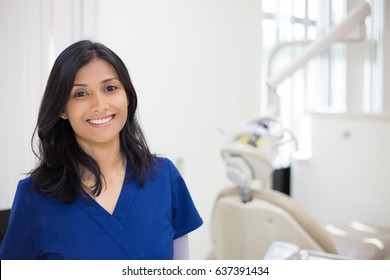 Closeup headshot portrait of friendly, cheerful, smiling confident female, healthcare professional in blue scrubs. isolated clinic hospital background. Patient visit.