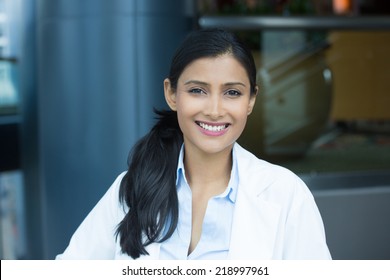 Closeup Headshot Portrait Of Friendly, Smiling Confident Female, Healthcare Professional With Lab Coat. Isolated Clinic Hospital Background. Patient Visit.