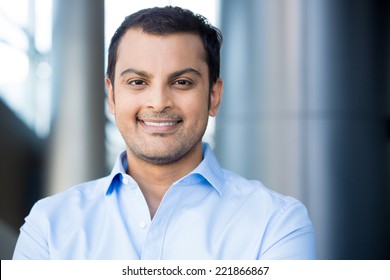 Closeup Headshot Portrait, Happy Handsome Business Man, Smiling, In Blue Shirt,confident And Friendly On Isolated Office Interior Background. Corporate Success