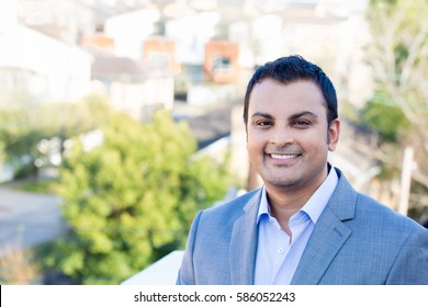 Closeup Headshot Portrait, Happy Handsome Business Man, Smiling, In Gray Suit Blazer,confident And Friendly, Isolated Outdoors Outdoors Background. Corporate Success