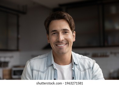Closeup headshot portrait of smiling young Caucasian man have webcam virtual zoom call online. Profile screen view picture of happy millennial male talk speak on video web conference on gadget.