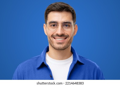 Close-up Headshot Portrait Of Young Male Teacher Face In Round Glasses Looking At Camera, Isolated On Blue Background