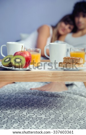 Similar – Image, Stock Photo Healthy breakfast on tray and couple lying in background