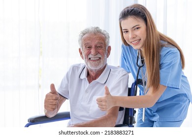 closeup healthy senior elder man with doctor nurse at homecare thumbs up happy smile 