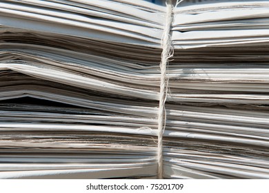 Closeup of a heap of old newspapers bound together