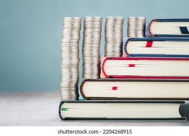 Closeup Heaps Of Money Coins Arranged On The Pile Of Textbooks Step By Step, Education Loans, Scholar, And Investment, Or Education Subsidy Money Concept