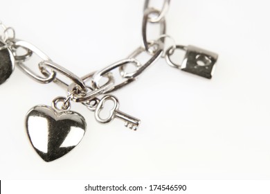 Closeup Of Heart And Key On Charm Bracelet