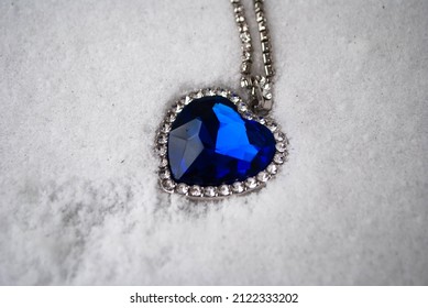 Close-up Of The Heart Of The Ocean Necklace On Snow. Blue Diamond In A Heart Shape. Diamond Necklace.