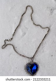 Close-up Of The Heart Of The Ocean Necklace On Snow. Blue Diamond In A Heart Shape. Diamond Necklace.