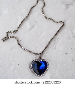 Close-up Of The Heart Of The Ocean Necklace On Snow. Blue Diamond In A Heart Shape. Diamond Necklace.