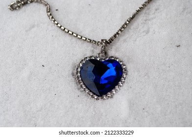 Close-up Of The Heart Of The Ocean Necklace On Snow. Blue Diamond In A Heart Shape. Diamond Necklace.