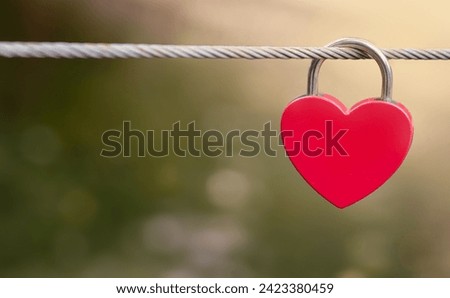 Close-up of a heart-shaped red padlock. Symbol of love.