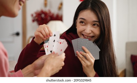 Closeup Of Hesitant Daughter Feeling Happy About Picking The Right Card While Playing Poker Game With Family At Home During Spring Holiday