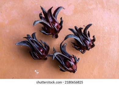 Close-up of hibiscus sabdariffa, or sorrel flowers. Sorrel is a rich red flower used to make sorrel drink in Caribbean countries at Christmas time. Holiday drink, raw flower, bowl of sorrel.