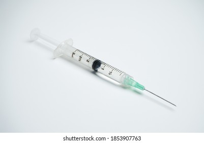 A closeup high angle shot of a medical needle on a white surface