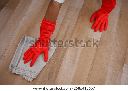 Close-Up And High Angle View Of Hands Wiping The Floor Using Rag