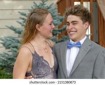 A Closeup Of A High School Couple Posing For The Camera And Having Fun.