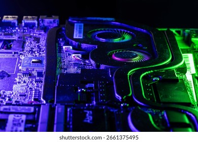 Close-up of a High-Performance GPU Cooling System with Dual Fans Under Dramatic Blue and Green Lighting
