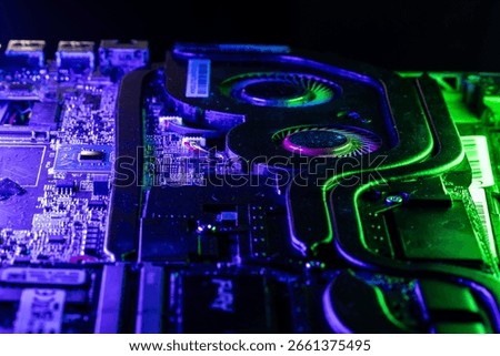 Close-up of a High-Performance GPU Cooling System with Dual Fans Under Dramatic Blue and Green Lighting