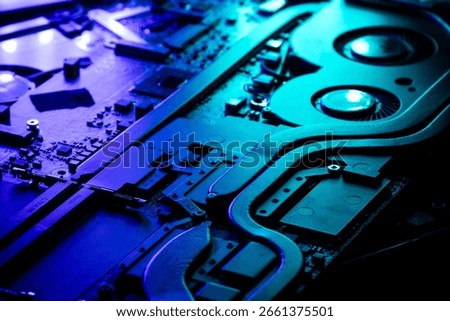 Close-up of a High-Performance GPU Cooling System with Dual Fans Under Dramatic Blue and Green Lighting