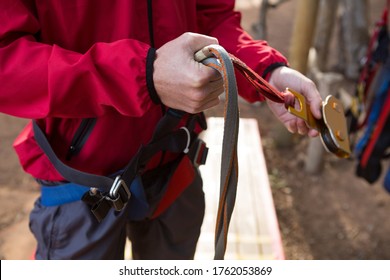 Close-up of hiker man adjusting his harness in the forest - Powered by Shutterstock