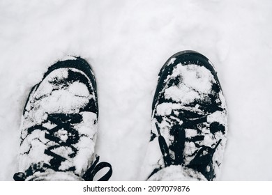 Closeup of hiking boots in the snow.