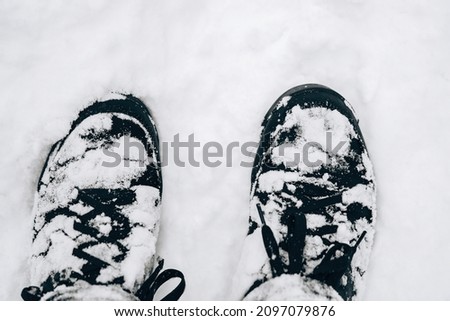 Closeup of hiking boots in the snow.