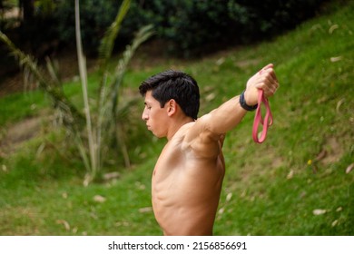 A Closeup Of A Hispanic Male Athlete Doing Gymnastics Outdoors