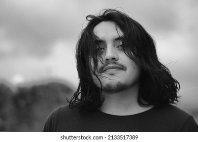 A Closeup Of A Hispanic Male Profile Looking At The Camera, Shot In Grayscale