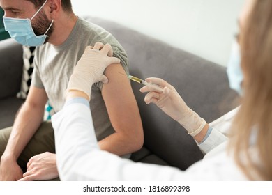 Closeup Of A Hispanic Man Getting A Vaccine From A Female Doctor In Her Office