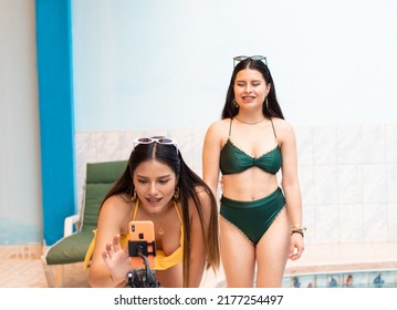 Close-up Of Hispanic Women Dancing Recording Content With A Phone Near The Pool,