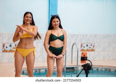 Close-up Of Hispanic Women Dancing Recording Content With A Phone Near The Pool,