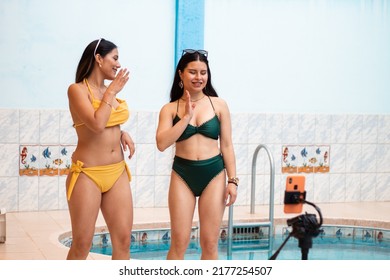 Close-up Of Hispanic Women Dancing Recording Content With A Phone Near The Pool,